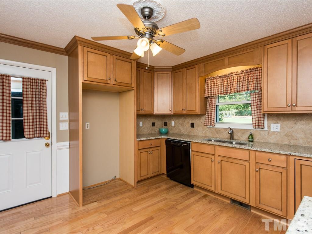3811 Donna Road Raleigh, NC 27604 - Photo 5 of 25 a kitchen with stainless steel appliances granite countertop a stove sink and cabinets