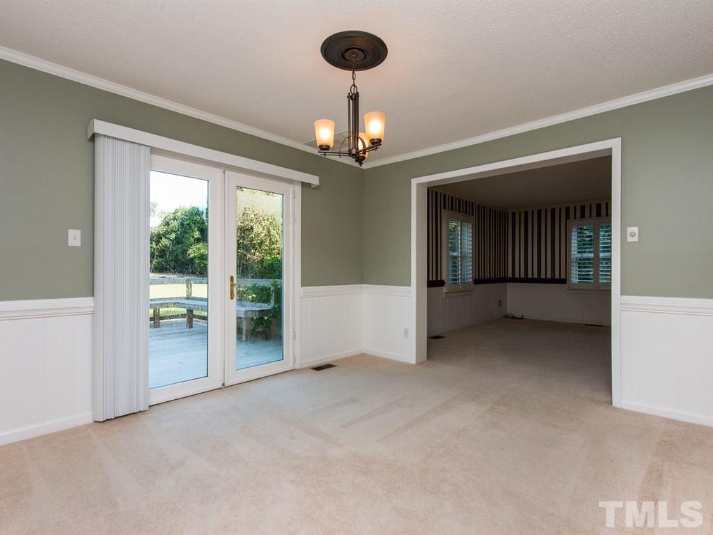 3811 Donna Road Raleigh, NC 27604 - Photo 7 of 25 an empty room that has a chandelier