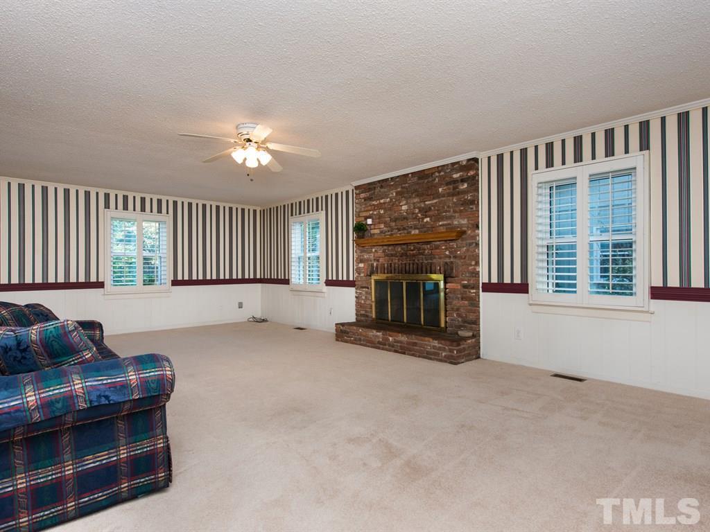 3811 Donna Road Raleigh, NC 27604 - Photo 9 of 25 a kitchen with furniture and a fireplace