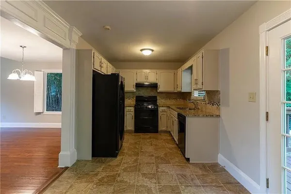 a kitchen with stainless steel appliances granite countertop a refrigerator and a sink