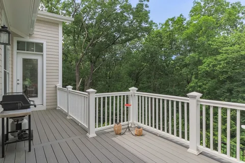 a view of balcony with wooden floor and fence