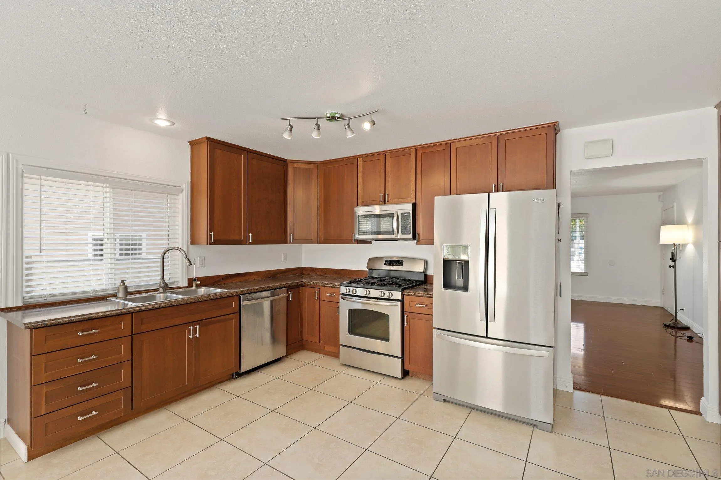 4141 Bryan Street Oceanside, CA 92056 - Photo 11 of 22 a kitchen with stainless steel appliances granite countertop a stove a refrigerator and a sink