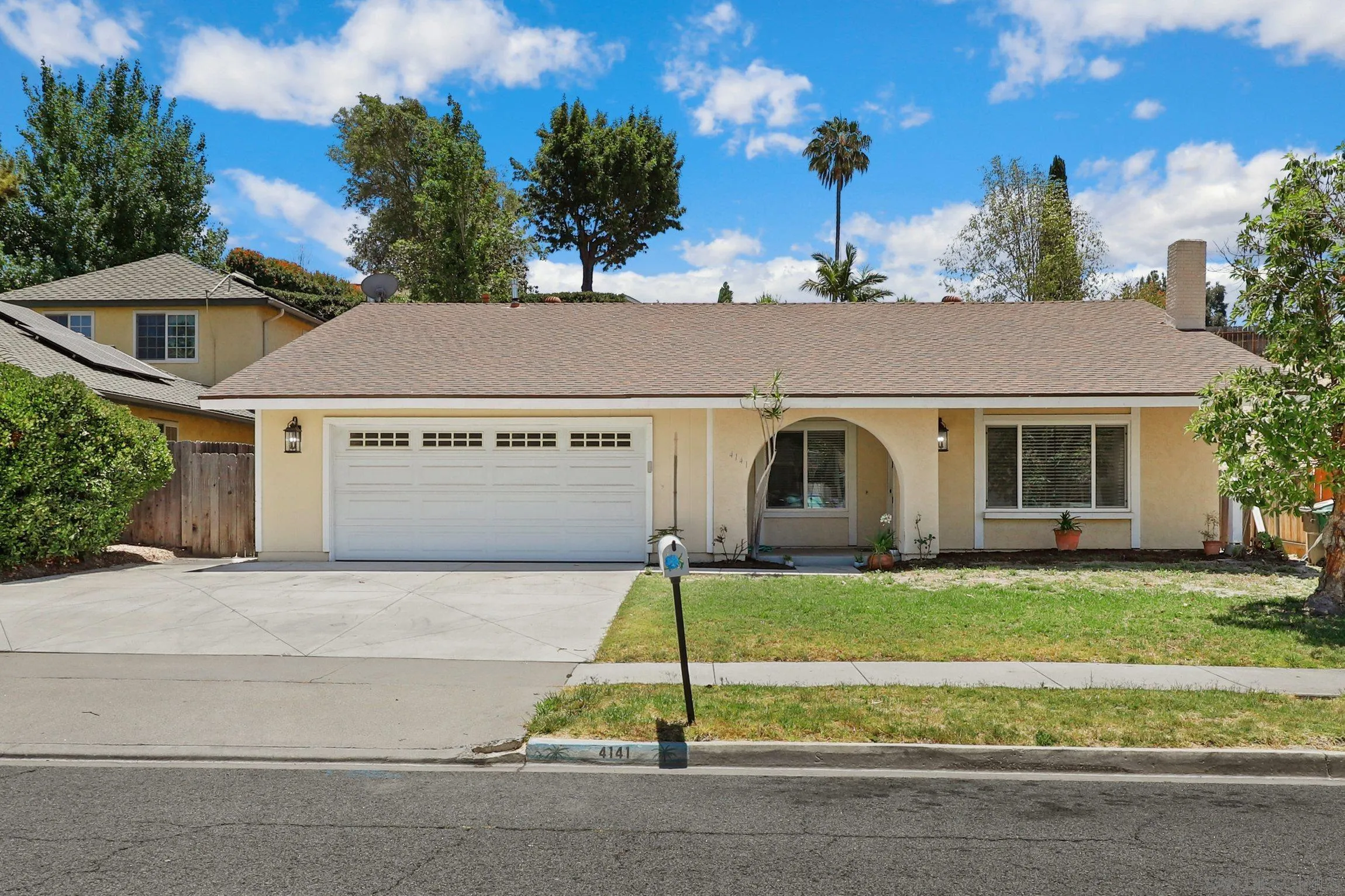 4141 Bryan Street Oceanside, CA 92056 - Photo 2 of 22 a front view of a house with a yard and garage