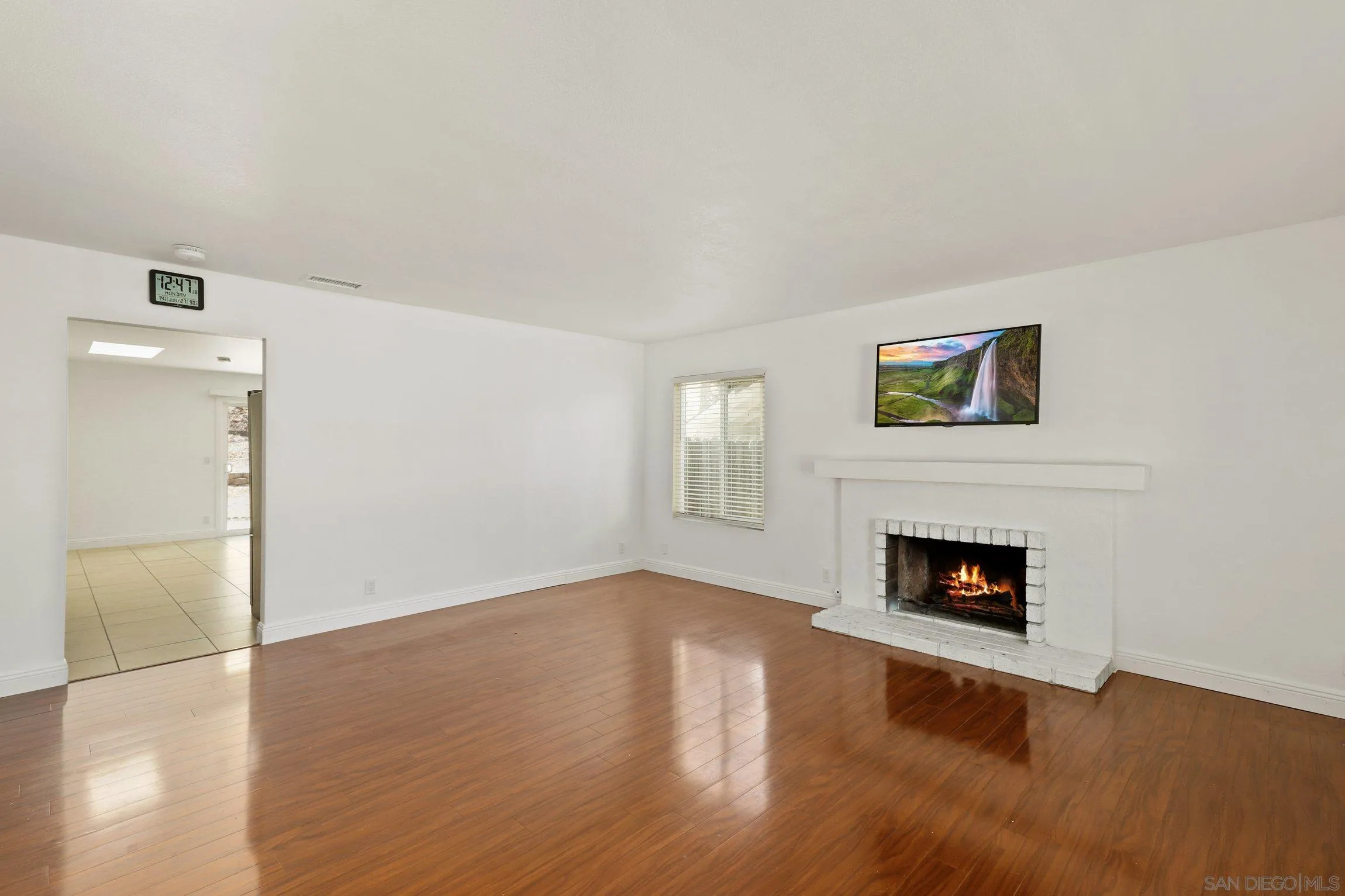 4141 Bryan Street Oceanside, CA 92056 - Photo 4 of 22 a view of an empty room with wooden floor and a fireplace