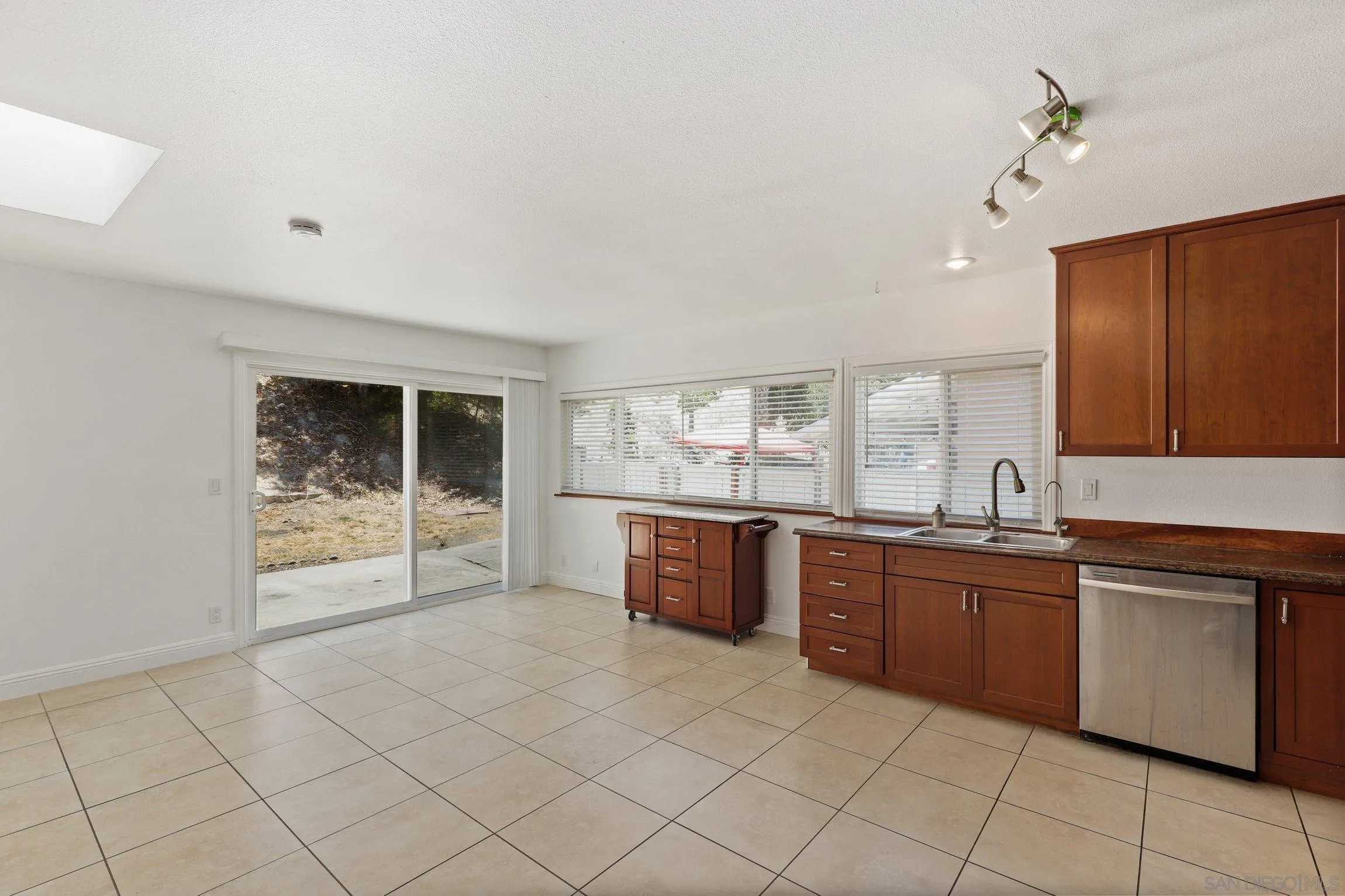 4141 Bryan Street Oceanside, CA 92056 - Photo 7 of 22 a large kitchen with granite countertop a sink and cabinets