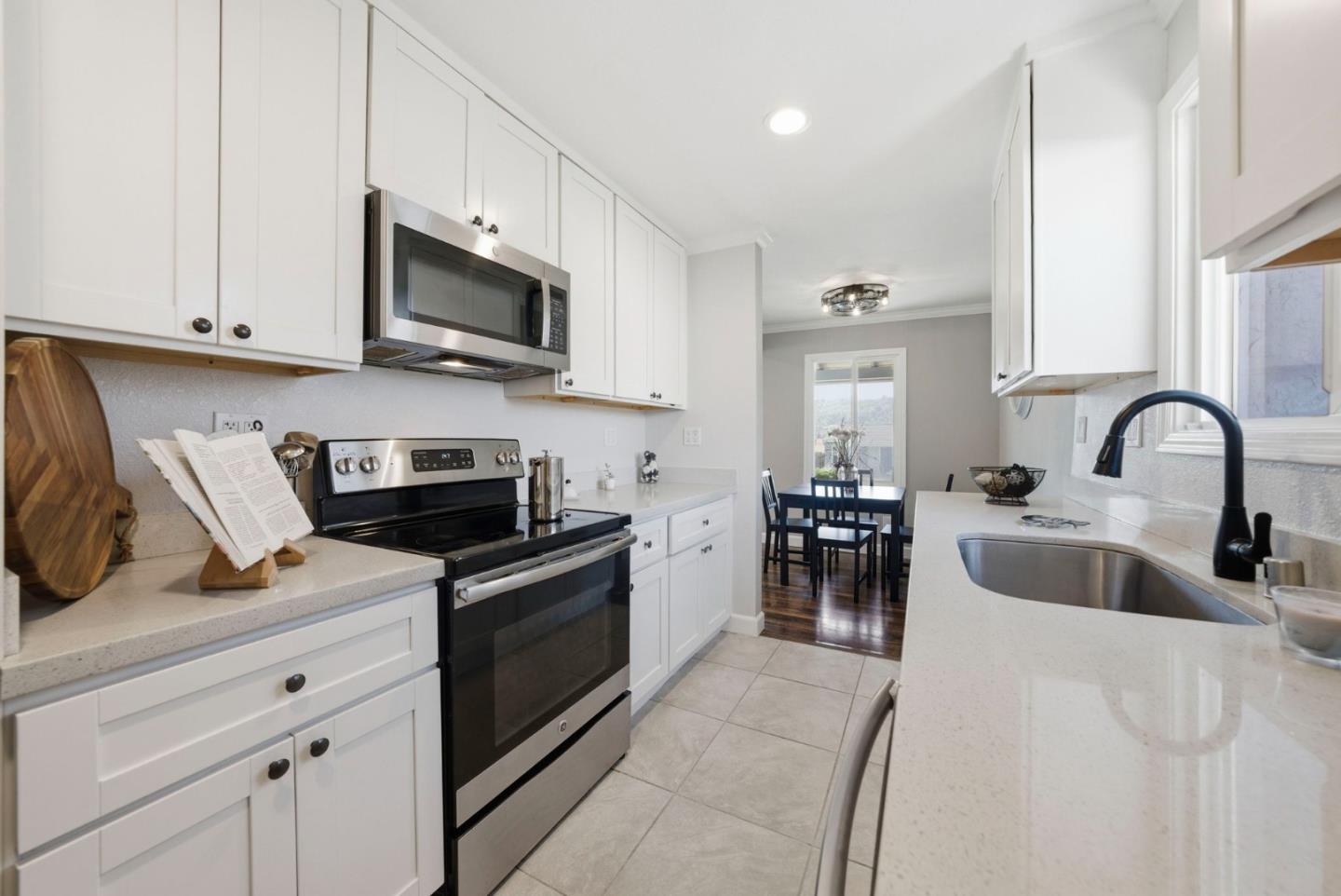 2793 Ruff Court Pinole, CA 94564 - Photo 17 of 53 a kitchen with stainless steel appliances granite countertop a stove a sink and a microwave