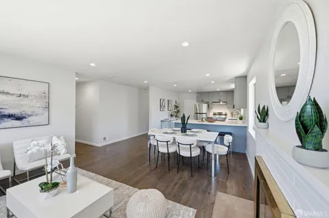 a kitchen with a sink white cabinets and stainless steel appliances