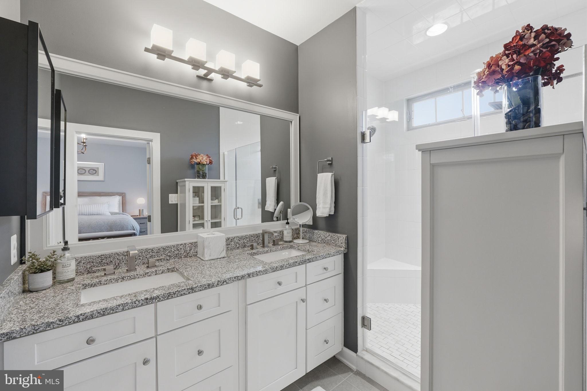 17812 Thomas Village Lane Sandy Spring, MD 20860 - Photo 22 of 37 a bathroom with a granite countertop double vanity sink and a mirror