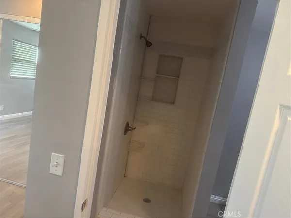 a bathroom with a glass shower door