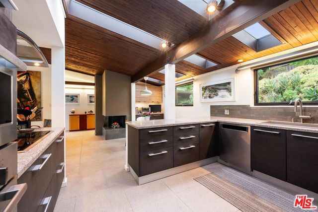 a kitchen with a sink and wooden cabinets