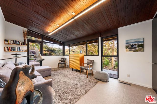 a living room with furniture and large windows