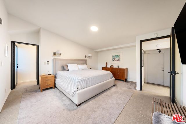 a bedroom with a bed and a lamp