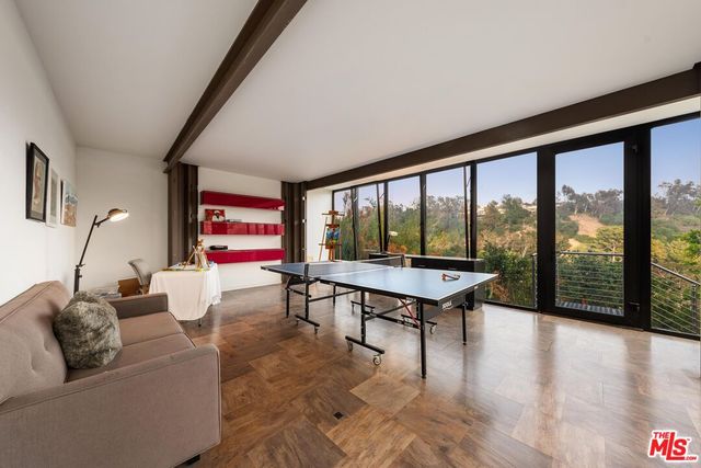 a living room with furniture and a floor to ceiling window