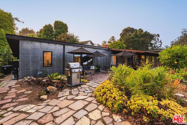 a view of a patio with table and chairs and potted plants