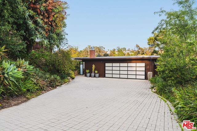 a view of a house with a yard and garage