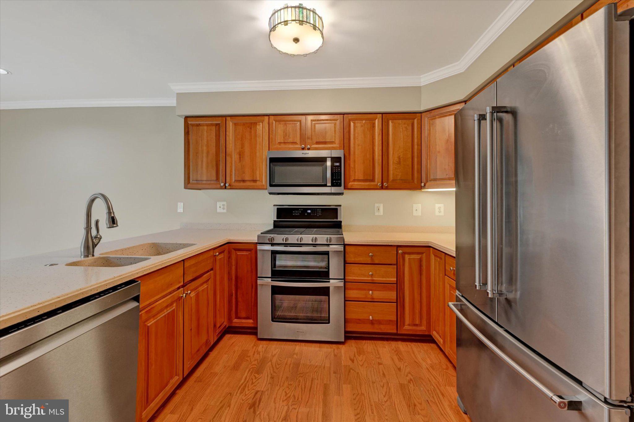 12310 Rosslare Ridge Road, Unit 405 Lutherville-Timonium, MD 21093 - Photo 12 of 36 Modern kitchen with warm wood tones.