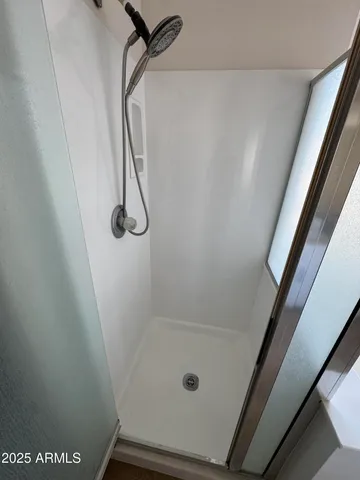 a bathroom with a glass shower door