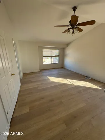 a view of room window and a ceiling fan