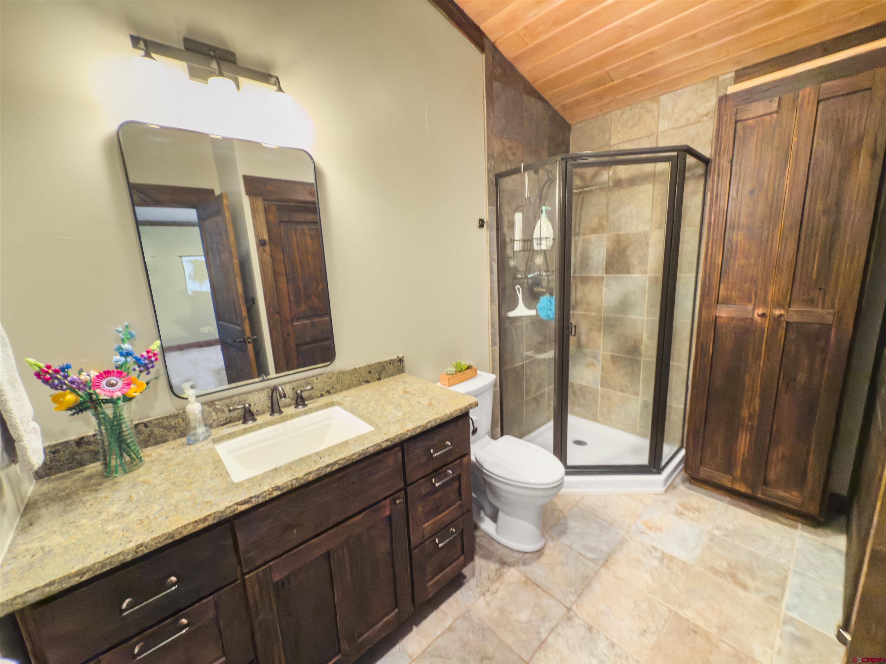684 Falcon Way Montrose, CO 81403 - Photo 21 of 43 a bathroom with a double vanity sink mirror and shower
