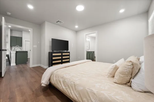 a bedroom with a bed and a flat screen tv