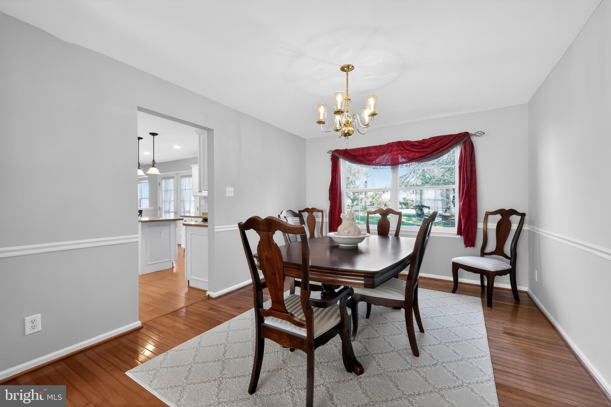 25 Country Lane Voorhees, NJ 08043 - Photo 11 of 36 a view of a dining room with furniture and wooden floor