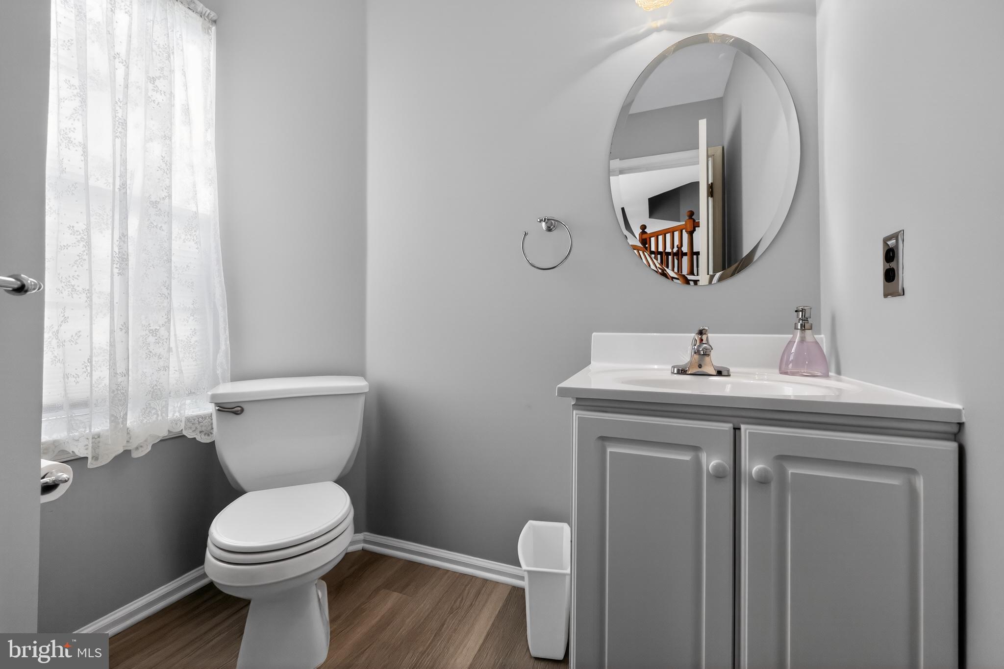25 Country Lane Voorhees, NJ 08043 - Photo 17 of 36 a bathroom with a toilet a sink and mirror