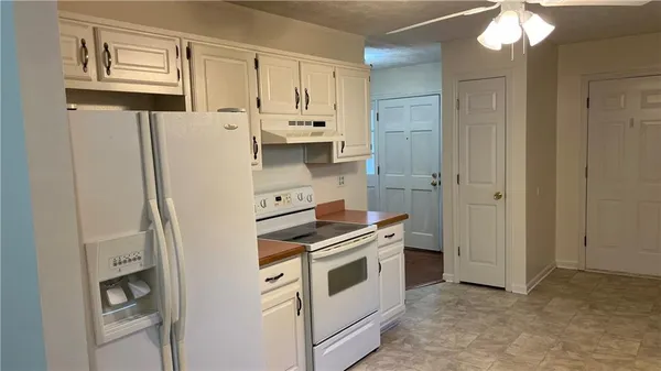 a kitchen with stainless steel appliances a refrigerator sink and cabinets