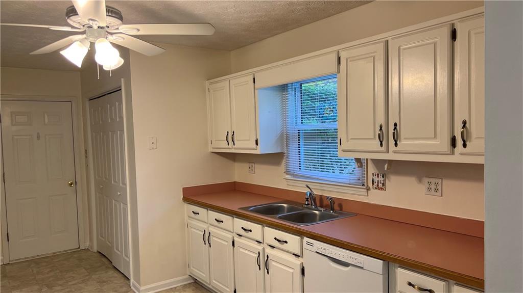 995 Old Spring Way Northeast Sugar Hill, GA 30518 - Photo 13 of 36 a kitchen with a sink cabinets and a window