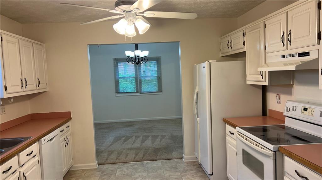 995 Old Spring Way Northeast Sugar Hill, GA 30518 - Photo 14 of 36 a kitchen with stainless steel appliances granite countertop a refrigerator a stove and a sink with dishwasher