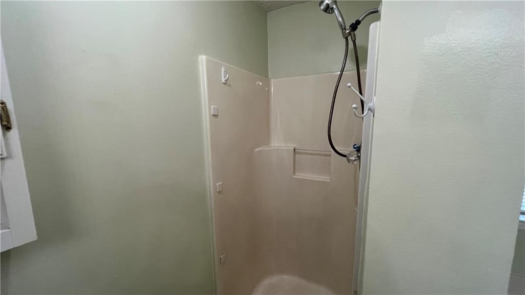 995 Old Spring Way Northeast Sugar Hill, GA 30518 - Photo 21 of 36 a bathroom with a glass shower door
