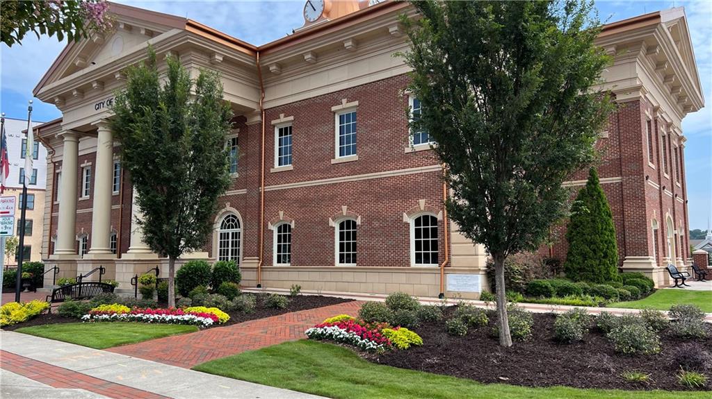995 Old Spring Way Northeast Sugar Hill, GA 30518 - Photo 33 of 36 a front view of a house with a yard