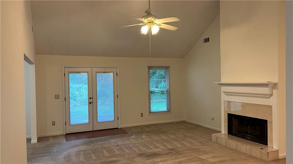 995 Old Spring Way Northeast Sugar Hill, GA 30518 - Photo 8 of 36 a view of an empty room with chandelier fan and fire place