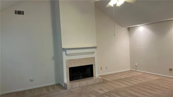 a room with a fireplace and chandelier