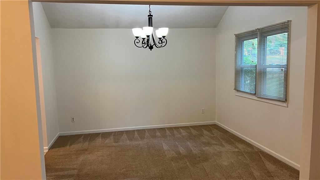 995 Old Spring Way Northeast Sugar Hill, GA 30518 - Photo 10 of 36 a view of an empty room with a window