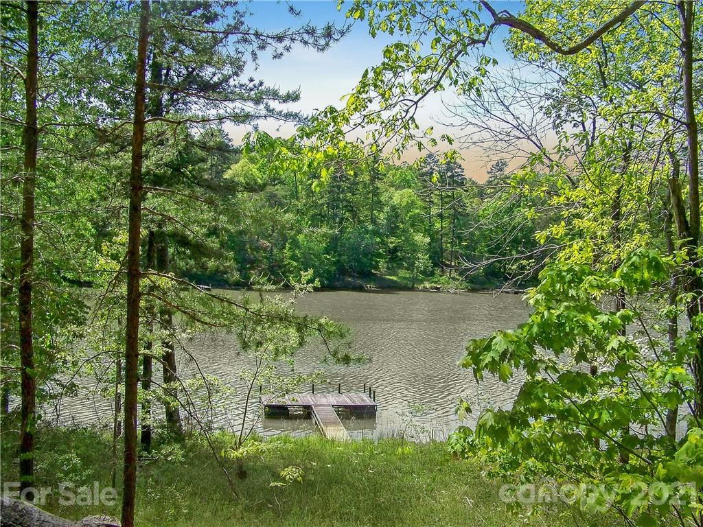 8 Parkway North Rd Mill Spring, Unit 8 Mill Spring, NC 28756 - Photo 7 of 16 a view of a garden with a bench