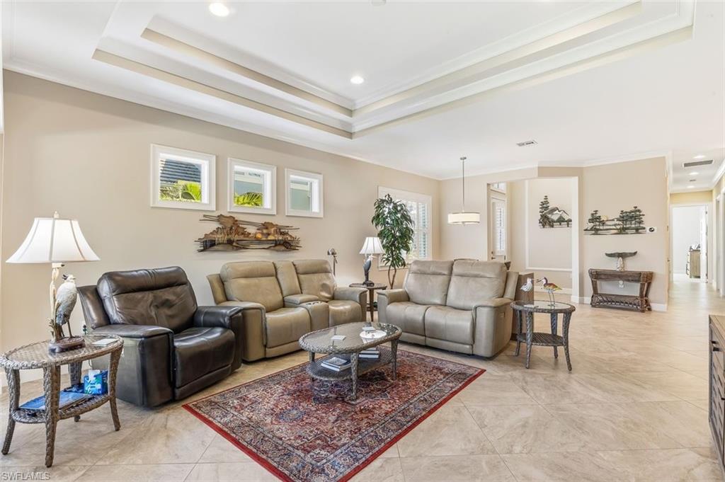 6931 Cay Court Naples, FL 34113 - Photo 8 of 24 Detailed view of crown molding, stainless steel appliances, recessed lighting, and a glass covered fireplace