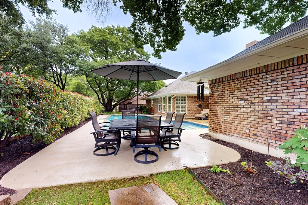 2405 Wing Point Lane Plano, TX 75093 - Photo 35 of 39 a view of outdoor sitting area with chairs and umbrella