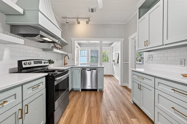 a kitchen with stainless steel appliances granite countertop a stove and a sink