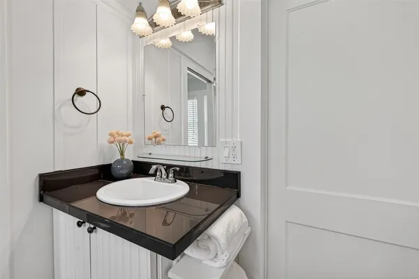 a bathroom with a sink and a mirror