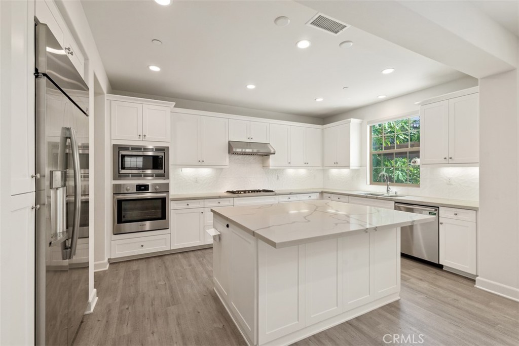 116 Windswept Irvine, CA 92618 - Photo 11 of 74 a kitchen with stainless steel appliances granite countertop a sink stove and refrigerator