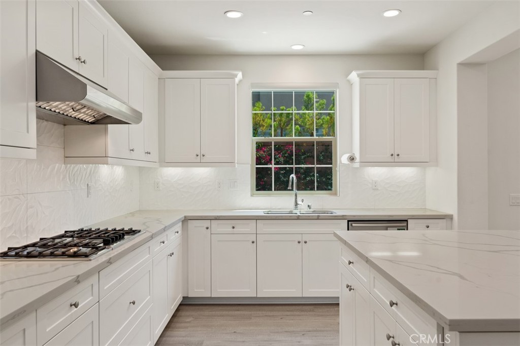 116 Windswept Irvine, CA 92618 - Photo 13 of 74 a kitchen with white cabinets and appliances