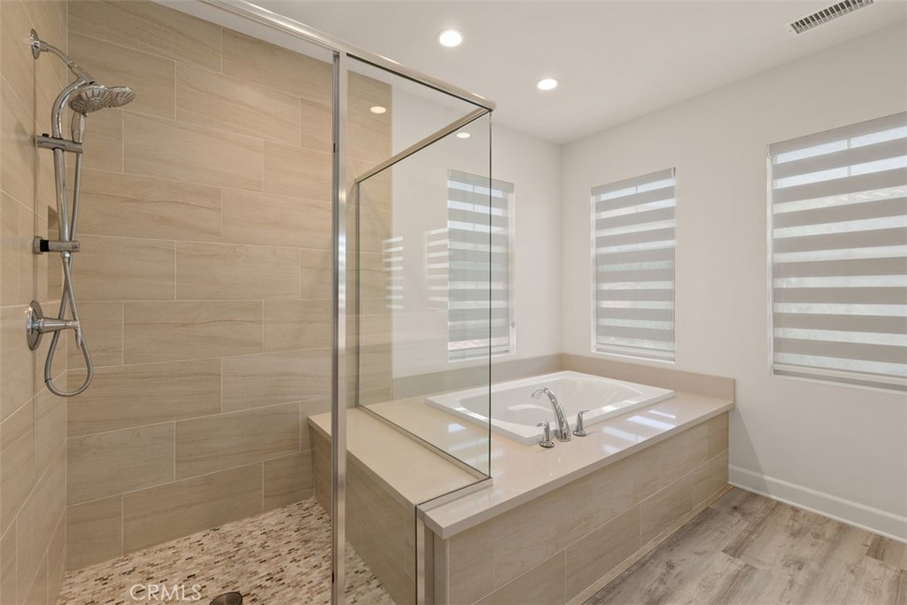 116 Windswept Irvine, CA 92618 - Photo 28 of 74 a bathroom with a tub and shower