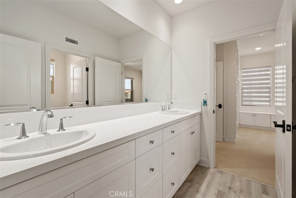 116 Windswept Irvine, CA 92618 - Photo 32 of 74 a bathroom with double vanity sinks and a mirror