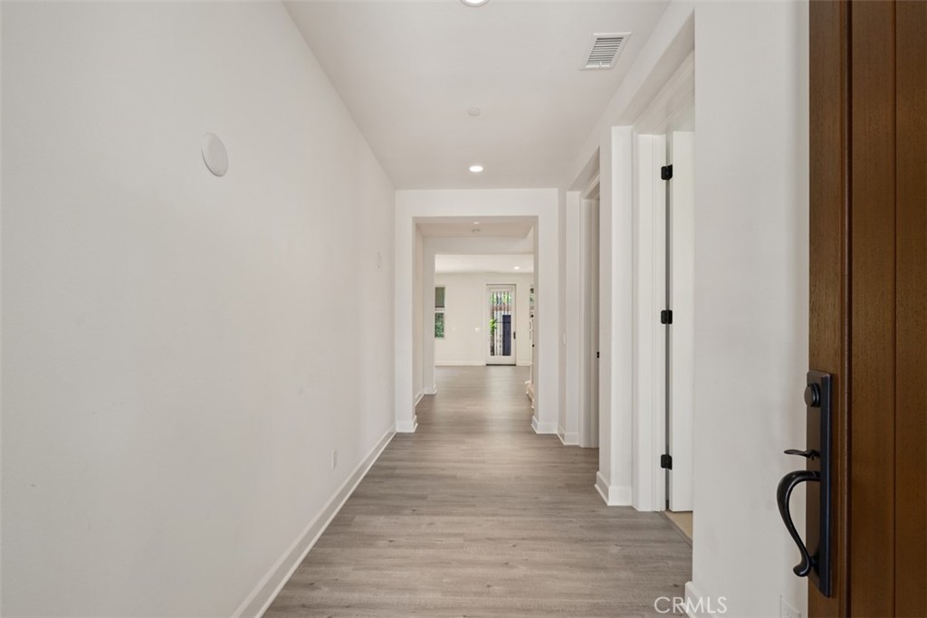 116 Windswept Irvine, CA 92618 - Photo 4 of 74 a view of a hallway with wooden floor