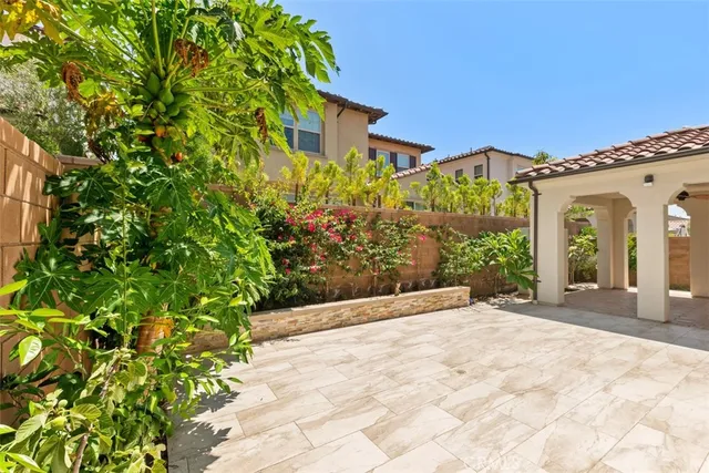 a front view of a house with a garden and trees