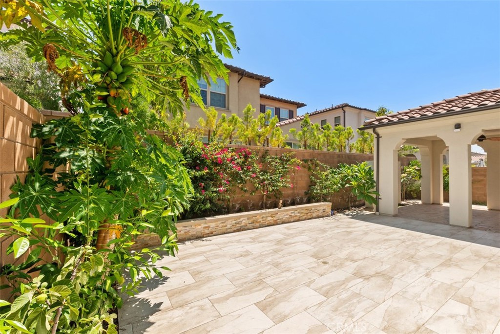 116 Windswept Irvine, CA 92618 - Photo 41 of 74 a view of a white house with a yard and plants