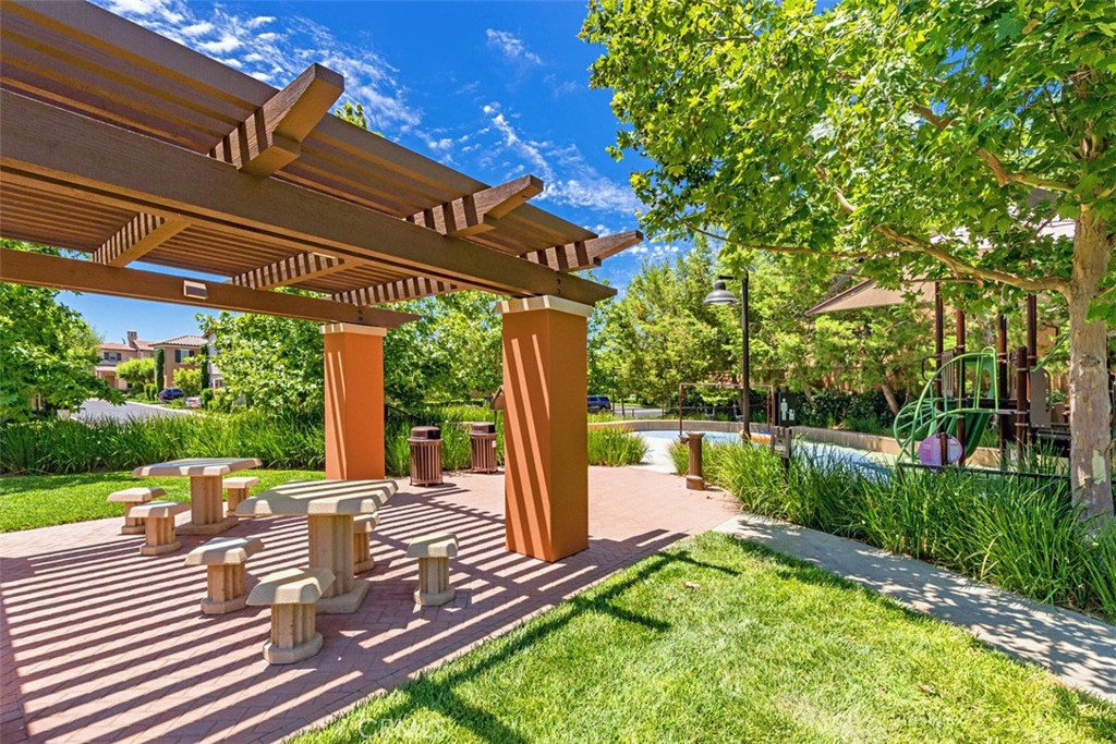116 Windswept Irvine, CA 92618 - Photo 48 of 74 a view of a patio with table and chairs potted plants with wooden floor and fence