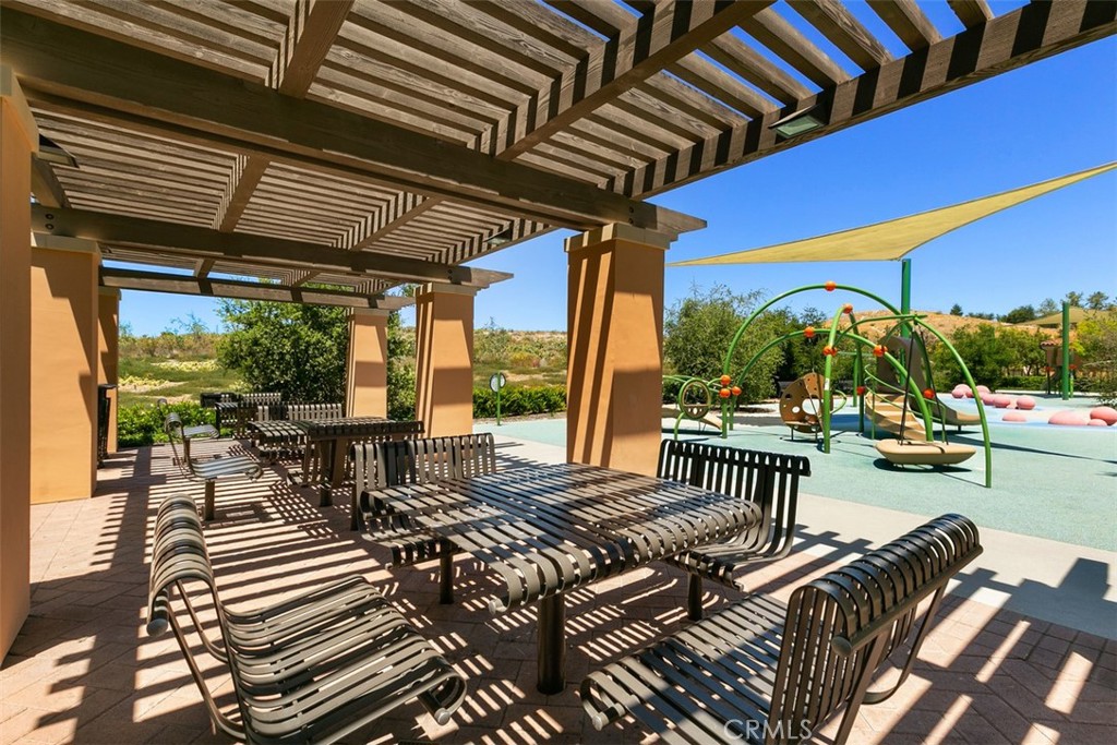 116 Windswept Irvine, CA 92618 - Photo 57 of 74 a view of a patio with table and chairs and potted plants