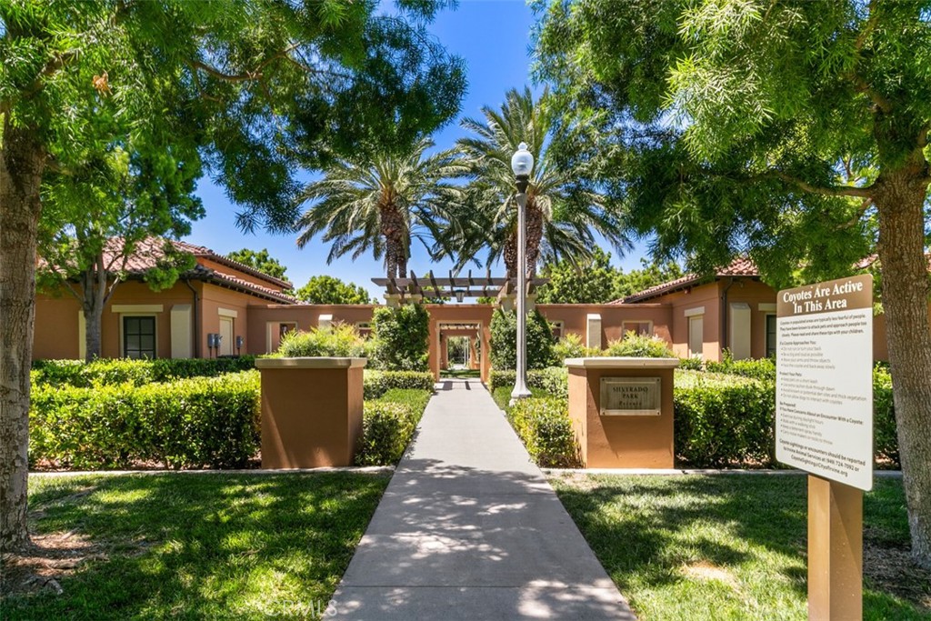 116 Windswept Irvine, CA 92618 - Photo 60 of 74 a front view of a house with a garden and trees
