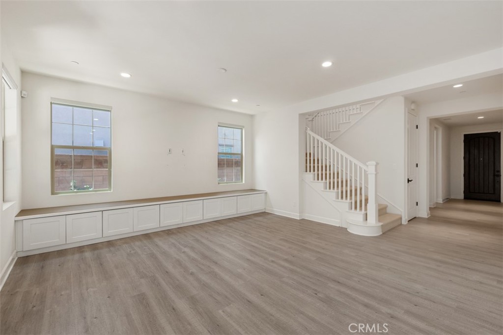 116 Windswept Irvine, CA 92618 - Photo 8 of 74 an empty room with wooden floor and windows